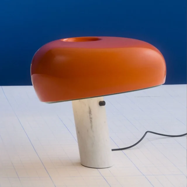 Snoopy lampinn frá Flos var hannaður af Achille og Pier Giacomo Castiglioni árið 1967 og hefur orðið eitt af þekktustu hönnunartáknum þeirra. Appelsínuguli liturinn gefur honum enn meiri karakter og gerir hann að skemmtilegri viðbót í hvaða rými sem er.